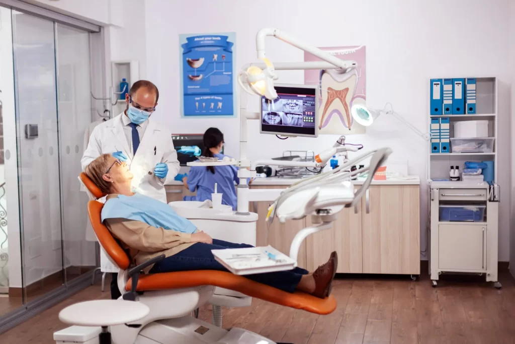 Dentist checking patient's proper bone integration before proceeding with implant.