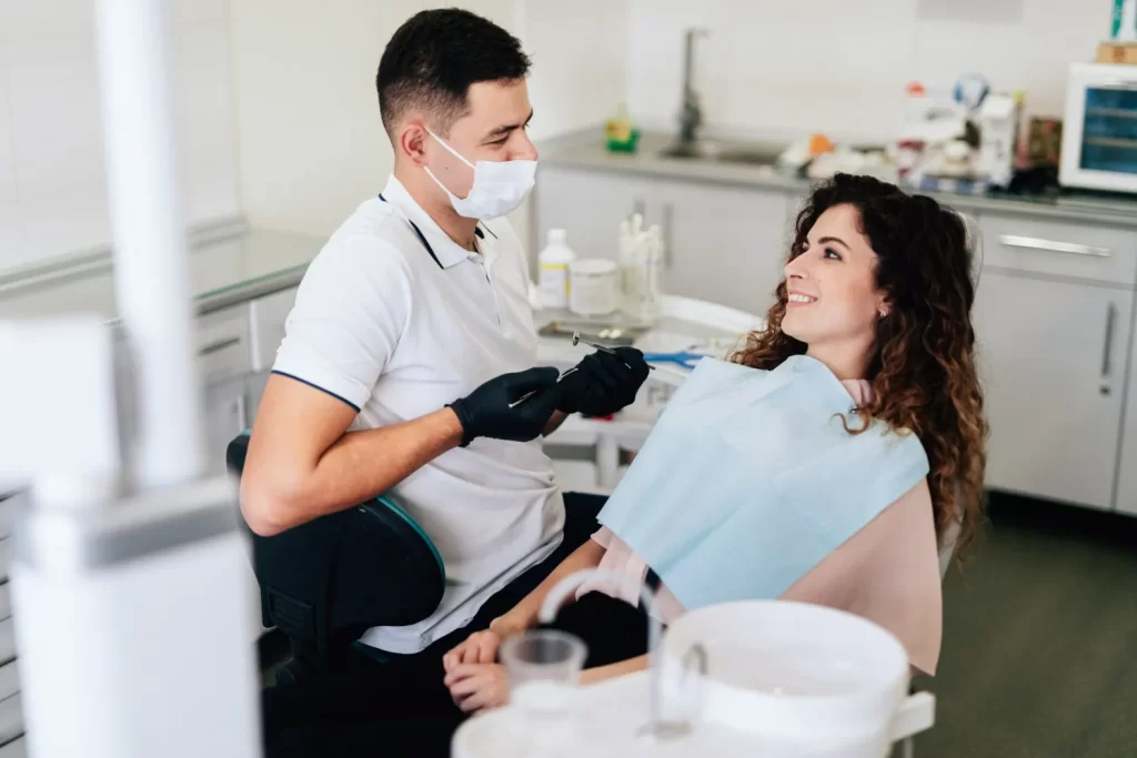 Dentist discussing options with patient before choosing the right filling type for her tooth.