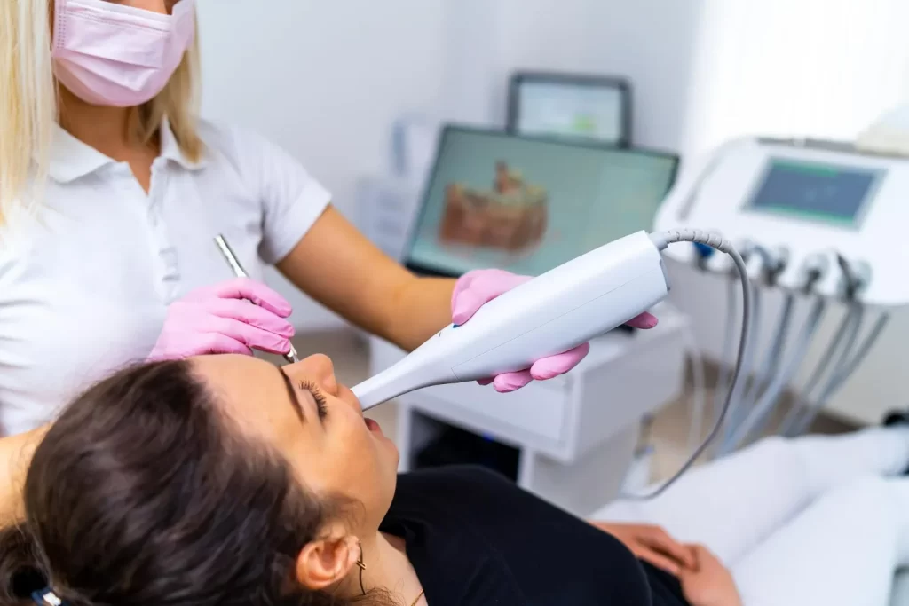 Intraoral scanning to record an impression for the implant abutment and final crown fit.