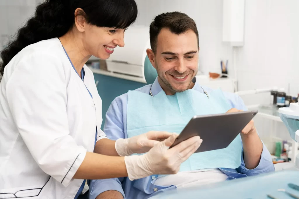 Dentist and patient reviewing a digital smile plan during a cosmetic dental consultation.