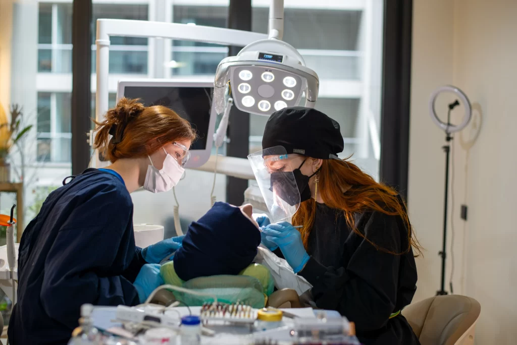 Dental team treating a patient during an implant-related appointment.