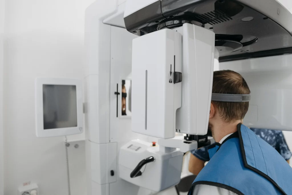 Patient undergoing CBCT imaging to assess wisdom tooth position and surrounding anatomy.